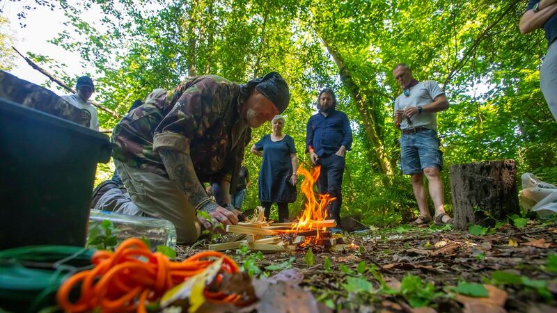 Shayne Phelan demonstrates how to light a fire using feather sticks at the Irish National Heritage Park at Ferrycarrig, Co Wexford. Photograph: Patrick Browne