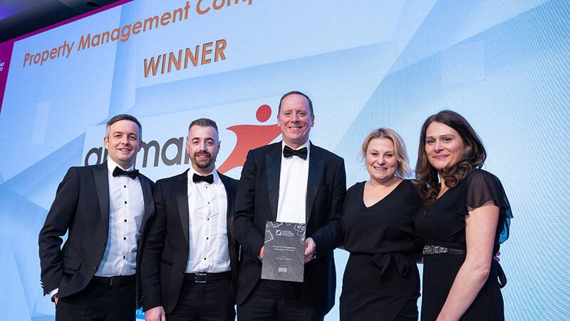 Noel Hennessy, senior operations manager at Synergy Security Solutions, presents the Property Management Company of the Year award to Aramark Property team