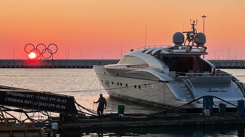 A worker in Sochi, on Russia’s Black Sea coast, fixes a wharf beside a luxury yacht and a reminder of the 2014 Winter Olympics which the city hosted. Photograph: Daniel McLaughlin