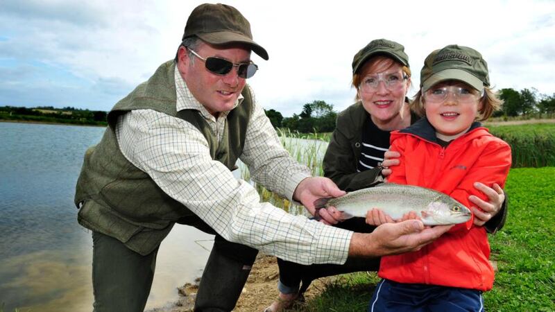 Garrett Ruigrok from Courtlough Trout Fisheries in Balbriggan, Co Dublin, with Alanna Gallagher and Sonny (6). Photograph: Aidan Crawley