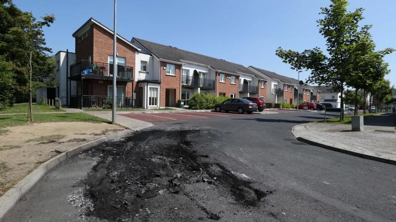 The scene at Phibblestown Wood, Clonsilla, where a Ford Galaxy suspected of being used as a getaway car in the shooting of a man at Beechfield Rise, Clonee this morning was found burned out. Photograph: Collins