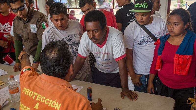 Migrants speak with immigration officials at a temporary camp in Matías Romero. Photograph: Brett Gundlock/The New York Times