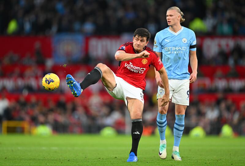 Harry Maguire passes the ball whilst under pressure from Erling Haaland during the Premier League match between Manchester United and Manchester City. Photograph: Michael Regan/Getty Images