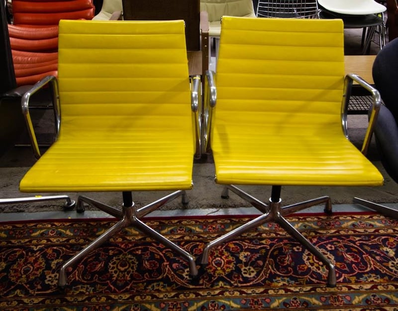 Two canary yellow original Vitra Eames EA 108 chairs are seeking €700-€1,000 through R J Keighery