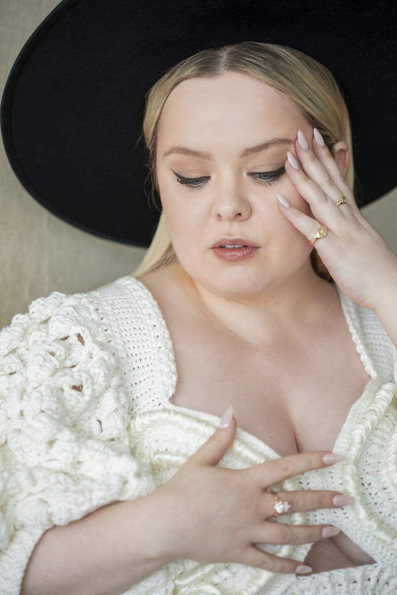 Actor Nicola Coughlan wearing a gold diamond Claddagh ring designed by Chupi