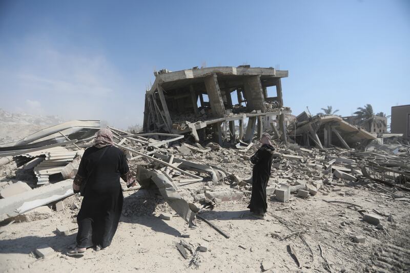 Palestinians inspecting the destruction left by Israeli forces after their partial withdrawal from Khan Younis. Photograph: Ismael Abu Dayyah/AP