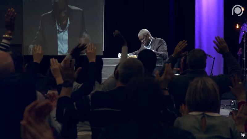 Gospel preacher Mamadou Karambiri from Burkina Faso addresses the congregation at the 2020 gathering of the Christian Open Door Church in Mulhouse, on February 18th. Video still: Christian Open Door Chuch/Handout via Reuters