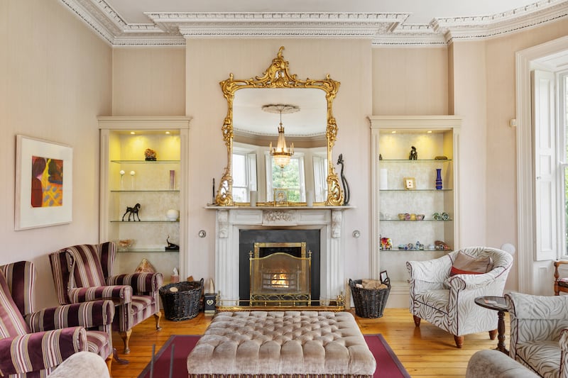 The main reception room is centred by a period fireplace