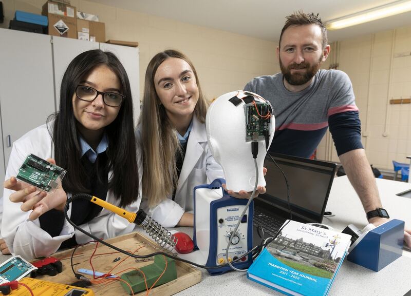 Teacher Rory Coote with students Sophie Creedon and Lydia Kelleher from St Mary’s secondary school in  Mallow, Co Cork.  The team’s project is an ‘investigation into sports-related cranial impacts and the design and development of wearable technology to better enable the measurement and recording of such head impacts’. Photograph:  Fennell Photography