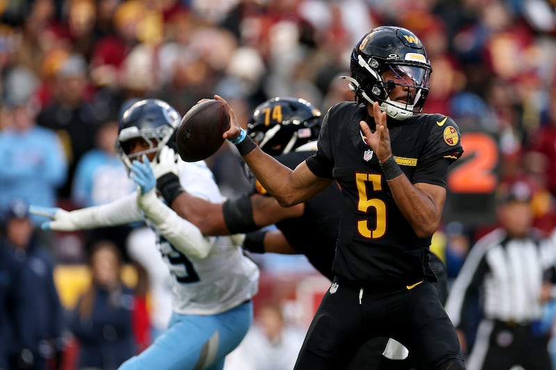 Jayden Daniels of the Washington Commanders throws a pass against the Tennessee Titans. Photograph: Scott Taetsch/Getty Images