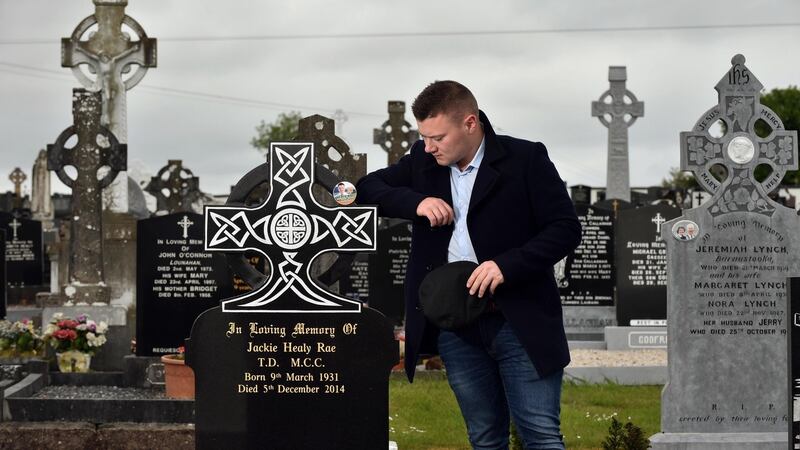 Jackie Healy-Rae jnr takes a break from canvassing to visit his grandfather Jackie’s grave in Kilgarvan, Co Kerry. Photograph: Don MacMonagle