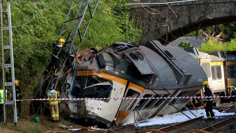 Spanish emergency services members and Civil Guard officers work at the site where a train derailed near O Porrino. Photograph: Slavador Sas/PA