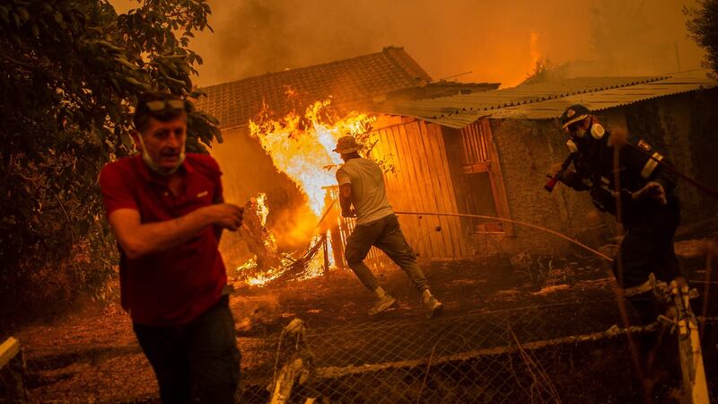 Forest fires approaching the village of Pefki on Evia island, Greece’s second largest island. Photograph: Angelos Tzortzinis/AFP via Getty