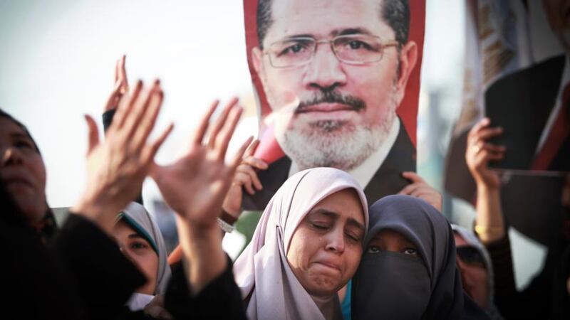 Protesters with a poster of ousted Egyptian President Mohammed Morsi. Photograph: Tara Todras-Whitehill/The New York Times