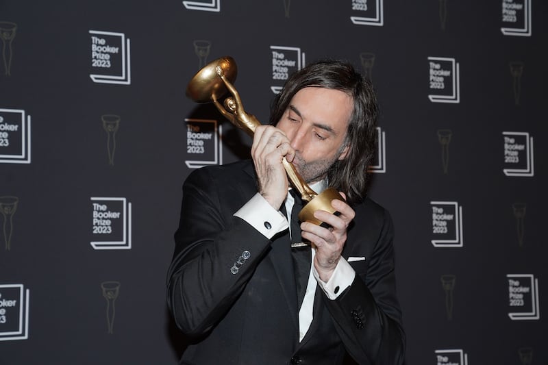 Paul Lynch with his trophy after winning the 2023 Booker Prize for the novel Prophet Song. Photograph: Lucy North/PA