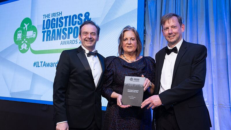 Dr. Jane O'Keeffe, Awards Judge, presents the Passenger Transport Company of the Year award to Liam Kenny and Ronan Murphy, Iarnród Éireann Irish Rail.