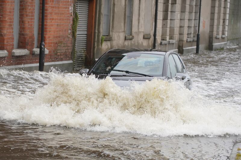 A car drives through flood water on Canal Quay in Newry November 1st. Photograph: Brian Lawless/PA Wire