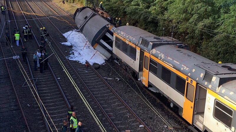 Spanish emergency services members and Civil Guard officers work at the site where a train derailed near O Porrino in Pontevedra. Photograph: Slavador Sas/PA