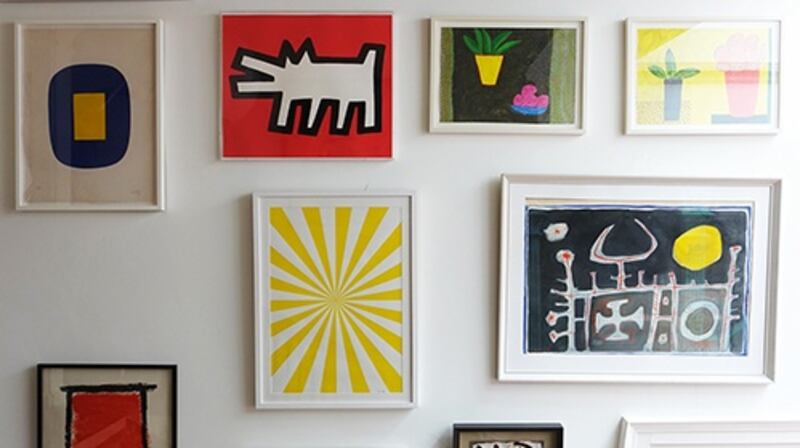 First floor landing. A large skylight lights up the first-floor landing and the wall of colourful pictures on the hall stairs. Photograph: by Christopher Simon Sykes.