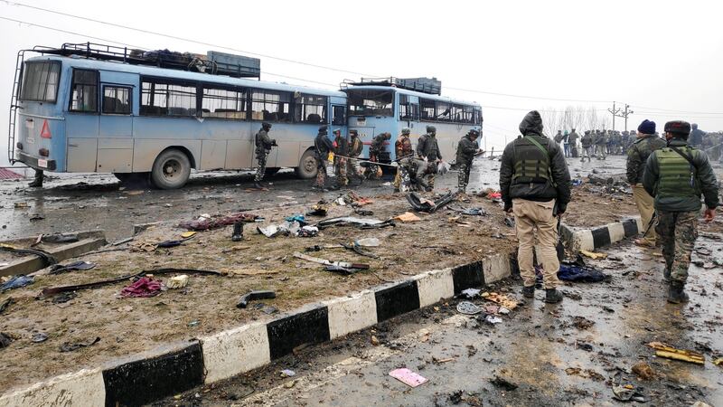 Indian soldiers examine the debris after Thursday’s attack in Lethpora, Kashmir. Photograph:  Younis Khaliq/Reuters