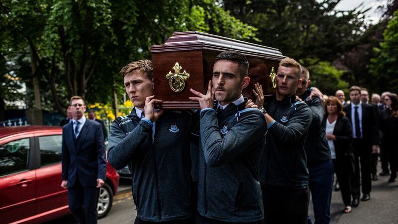 Brian Howard, Niall Scully and Ciarán Kilkenny (right, behind) of the Dublin senior football team carry the coffin of Anton O’Toole into the Mount Argus church in Kimmage. Photograph: James Forde