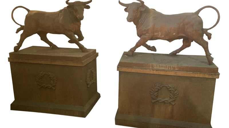 A pair of cast iron bulls on plinths which Derry sourced from a London dealer