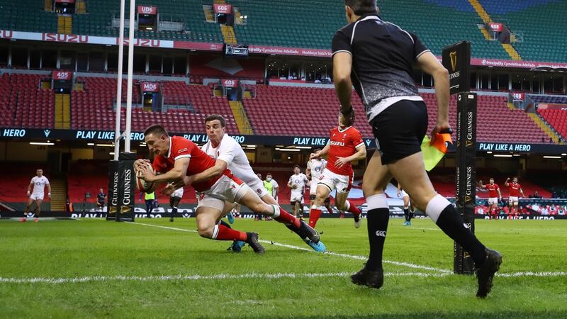 Josh Adams scores the opening try for Wales against England. Photograph: Michael Steele/Getty