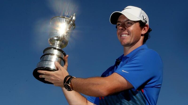 A jubilant Rory McIlroy holds aloft the Australian Open trophy after victory during day four of the prestigious event at Royal Sydney Golf Club. Photograph:  Mark Metcalfe/Getty Images