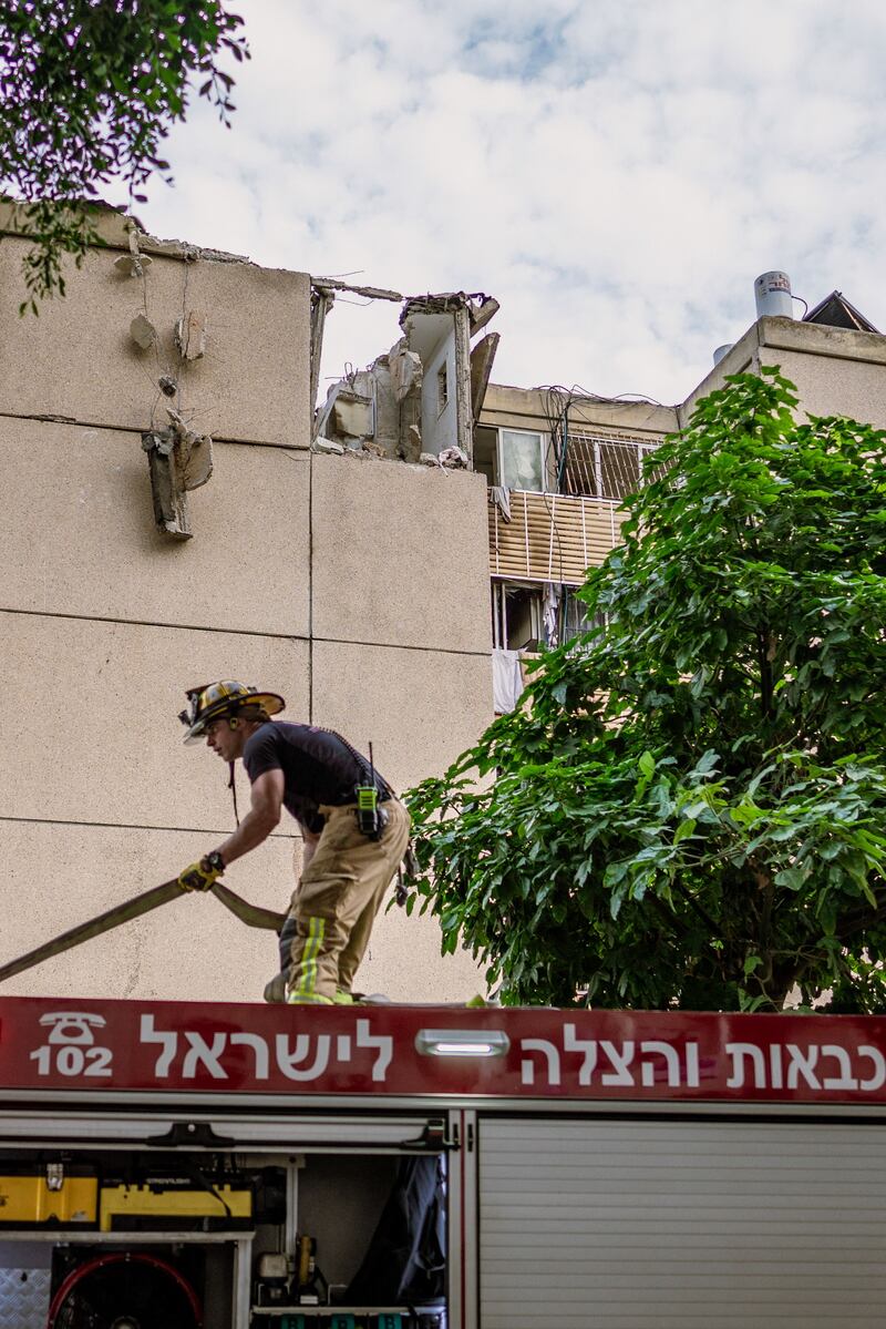 Israeli firefighters and rescue teams assess the destruction by a rocket attack in Tel Aviv. Photograph: Dima Vazinovich/AFP via Getty