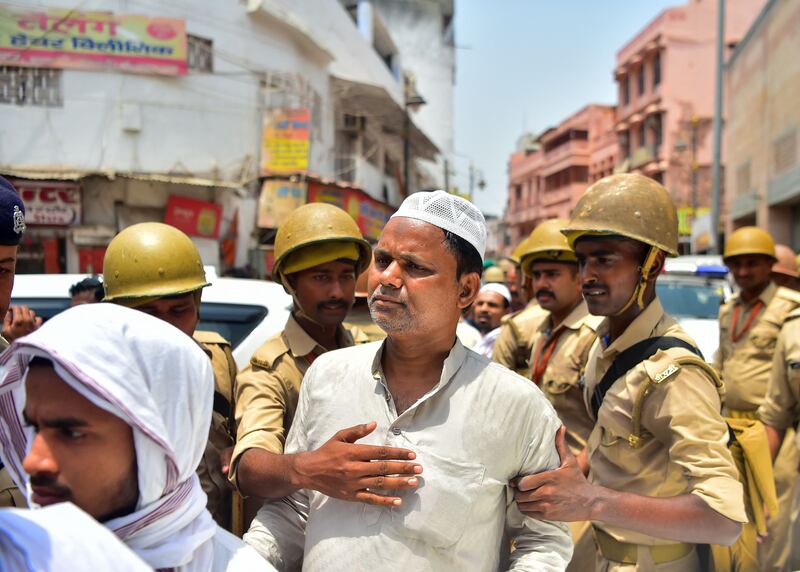 Policemen stand guard as Muslim devotees arrive to offer Friday noon prayer at the Gyanvapi mosque in Varanasi, in May 2022. Photograph: Sanjay Kanojia/AFP via Getty Images