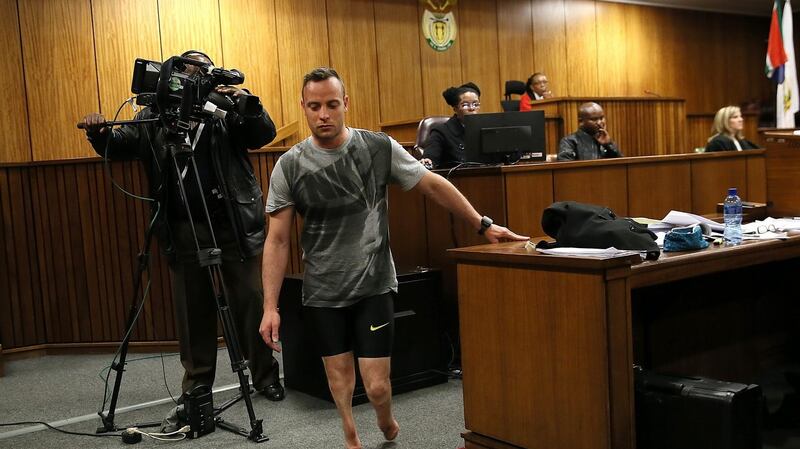 Oscar Pistorius (C) walks without his prosthetic legs in the courtroom during proceedings on the third day of his sentencing hearing at the High Court in Pretoria, South Africa, 15th June 2016. The Supreme Court of South Africa overturned the High Court’s verdict in December 2015, with the South African Paralympian Oscar Pistorius now facing a sentencing for murder of his girlfriend Reeva Steenkamp on 13th February 2013. Photograph: Alon Skuy/EPA