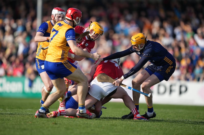 Members of both teams get involved as Patrick Horgan of Cork and Adam Hogan of Clare clash on the ground. Photograph: James Lawlor/Inpho