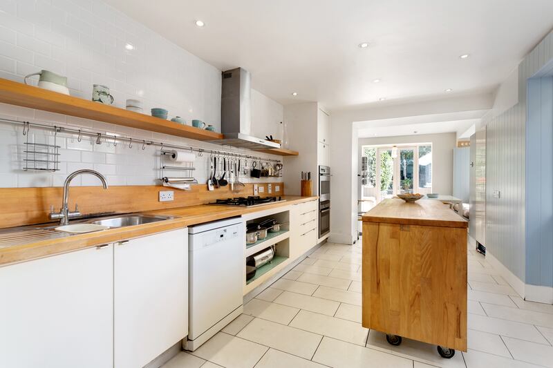 The kitchen island is on wheels so it can be moved for dancing