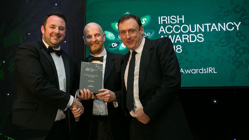 Micheal O’Neill, CEO, OmniPro presents the Excellence in Education & Training award to Philip Burke and Owen O’Reilly, City Colleges