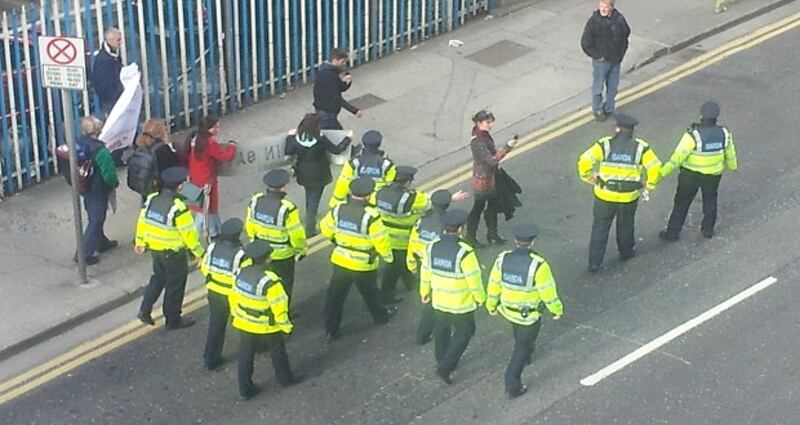 Gardaí escorting protesters down Tara Street this afternoon.