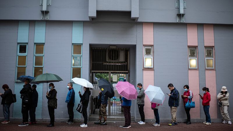 Residents queue at a Covid-19 testing facility in Hong Kong. Photograph:  Louise Delmontte/Bloomberg