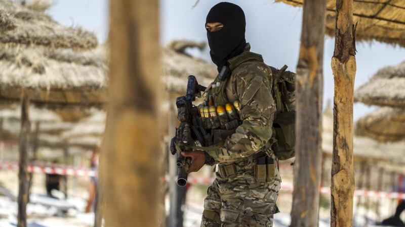 A member of Tunisia’s special forces inspects the beachside of the Imperial Marhaba resort. Photograph: Zohra Bensemra/Reuters