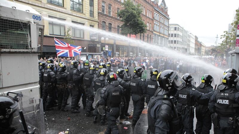 Loyalist protesters clash with riot police in the centre of Belfast on Friday.