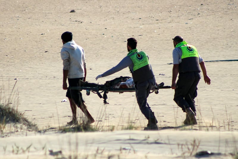 The body is removed of one of two fishermen killed in an Israeli strike on a beach at Tyre. Photograph: Kawnat Haju/AFP