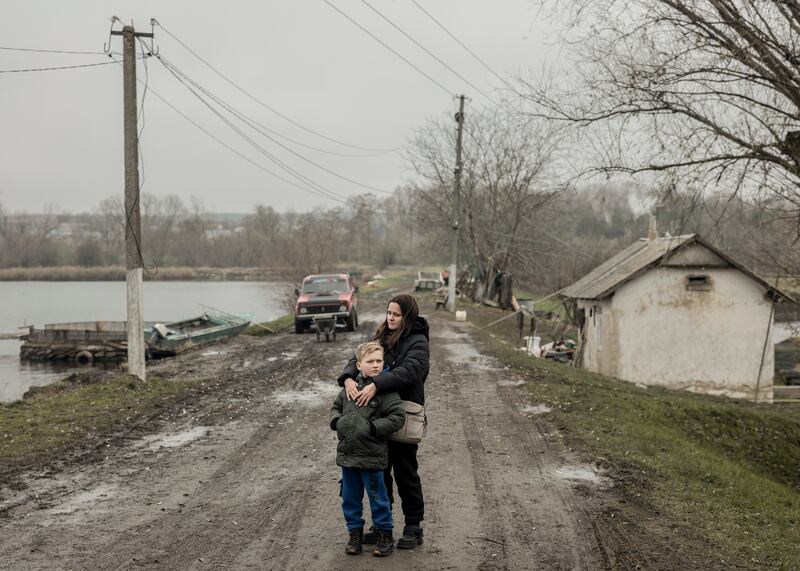 Ivanna Bevtsek, the widow of Serhii Bolhov, with her son, Valentyn, in Oshykhliby, Ukraine. Photograph: Emile Ducke