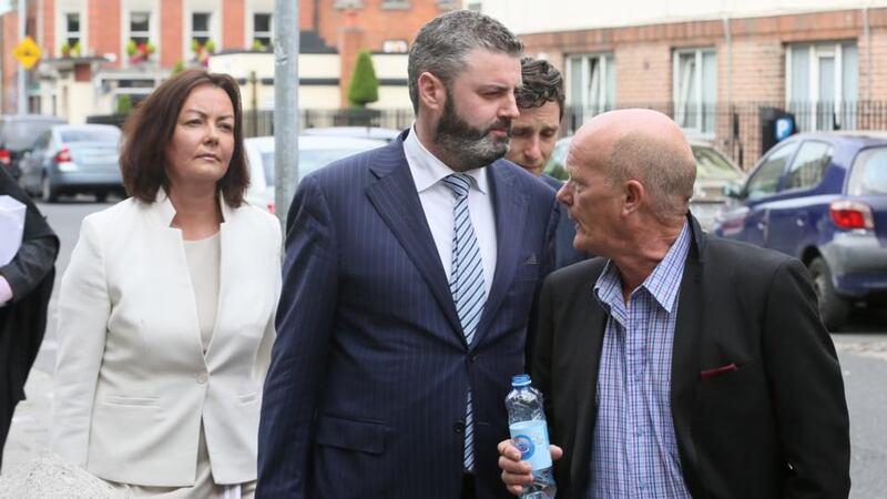 Former Clerys worker John Crowe (with bottle) addresses Deirdre Foley as she leaves the Four Courts after a High Court action involving Clerys. Photograph: Collins Courts