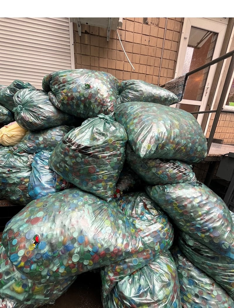 Bags filled with plastic bottle tops which must be sorted by hand before recycling in order to generate income for a Key to the Future day centre. Photograph: Chris Fitzpatrick.