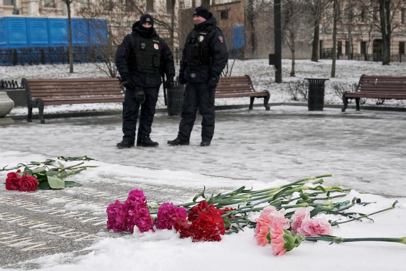 Russian police officers stand guard next to the Solovetsky Stone, a monument to political repression, as the late Russian opposition leader Alexei Navalny was mourned in Moscow on the first anniversary of his death. Photograph: Tatyana Makeyeva/AFP/Getty Images 