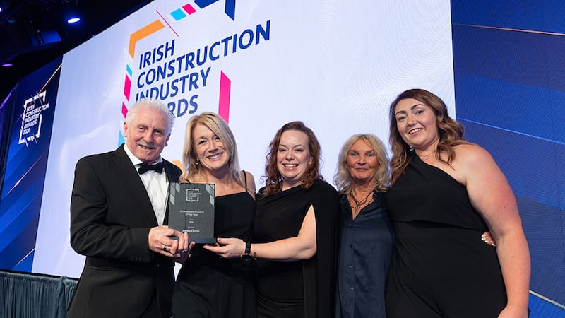 Pat McVey, managing director at P McVey Building Systems, presents the architecture practice of the year award to the RKD team