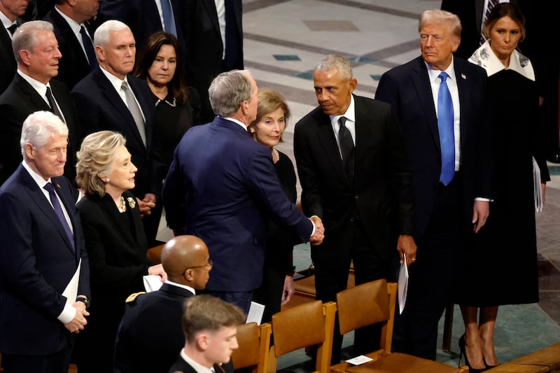 Former US president Barack Obama greets former US president George W Bush following the state funeral for Jimmy Carter at Washington National Cathedral. Photograph: Chip Somodevilla/Getty Images