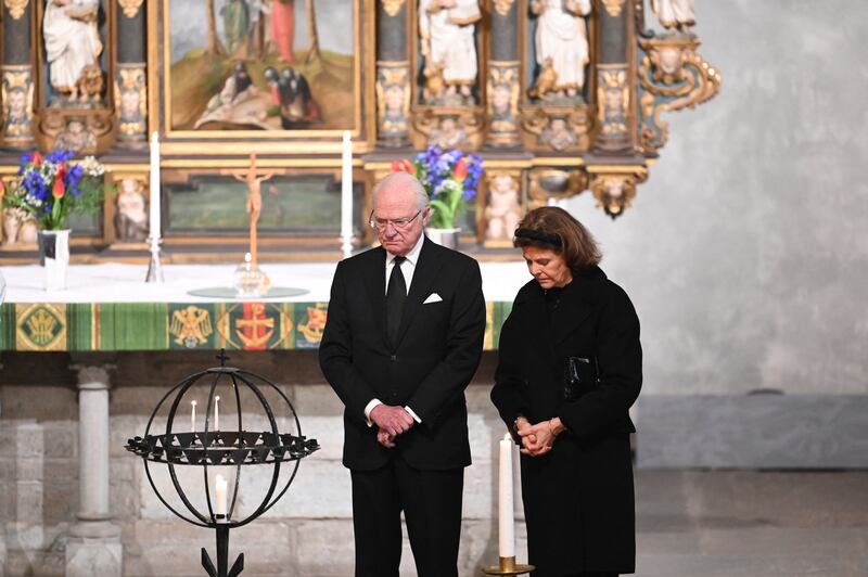 King Carl XVI Gustaf of Sweden and Queen Silvia light a candle at a memorial service to victims of the mass shooting, in Saint Nicholas church, Orebro, Sweden. Photograph: Jonathan Nackstrand/AFP/Getty      