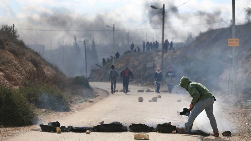 Israeli ettlers burn tires in the West Bank outpost of Amona. Photograph: Oded Balilty/AP Photo