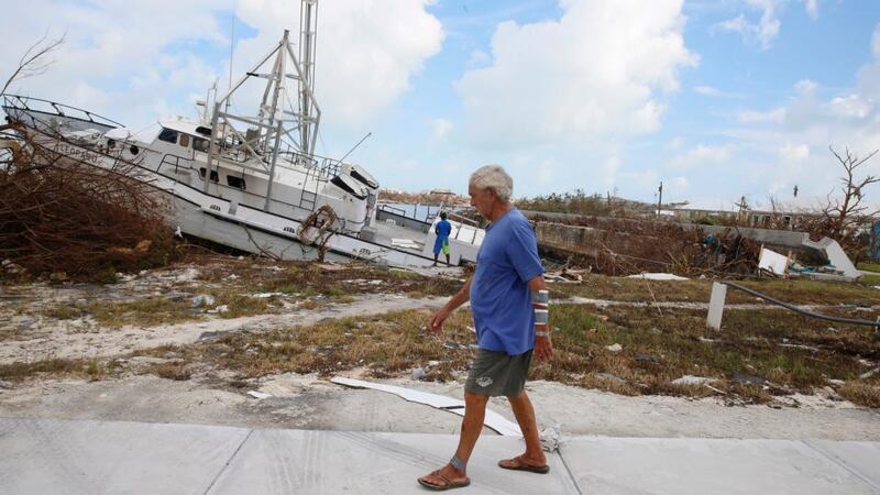 Mike Lowe, who is half blind and suffers from diabetes, walks past a marroned boat in Great Abaco Island in the Bahamas. Photograph: Jose Jimenez/Getty