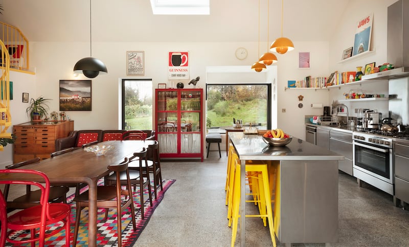 A curved Italian stainless steel kitchen was beyond their means but inspired an internet search that introduced them to Stainless Steel Solutions in Co Kilkenny. It includes an island with banana yellow Tolix barstools and a mid-century dining table and chairs