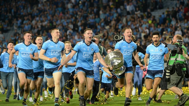 Brian Fenton and Ciaran Kilkenny  lead the celebrations in front of the Hill. Photograph: Dara Mac Dónaill/The Irish Times